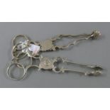 Two pairs of silver sugar tongs. Each 11.5 cm long. 59.1 grammes.