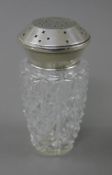 A silver topped sugar sifter. 14 cm high.