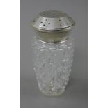 A silver topped sugar sifter. 14 cm high.