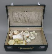 A vintage case containing various Art Deco tea sets.