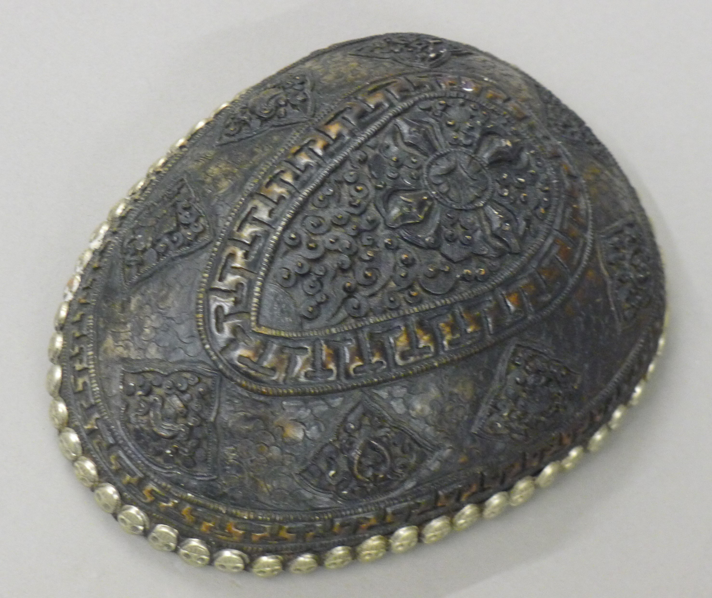 A decorative Tibetan type ornament. 13 cm wide.