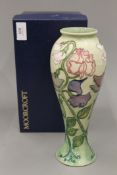 A boxed Moorcroft Sweet Pea vase. 27 cm high.