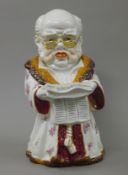 A porcelain figural tobacco jar. 23.5 cm high.