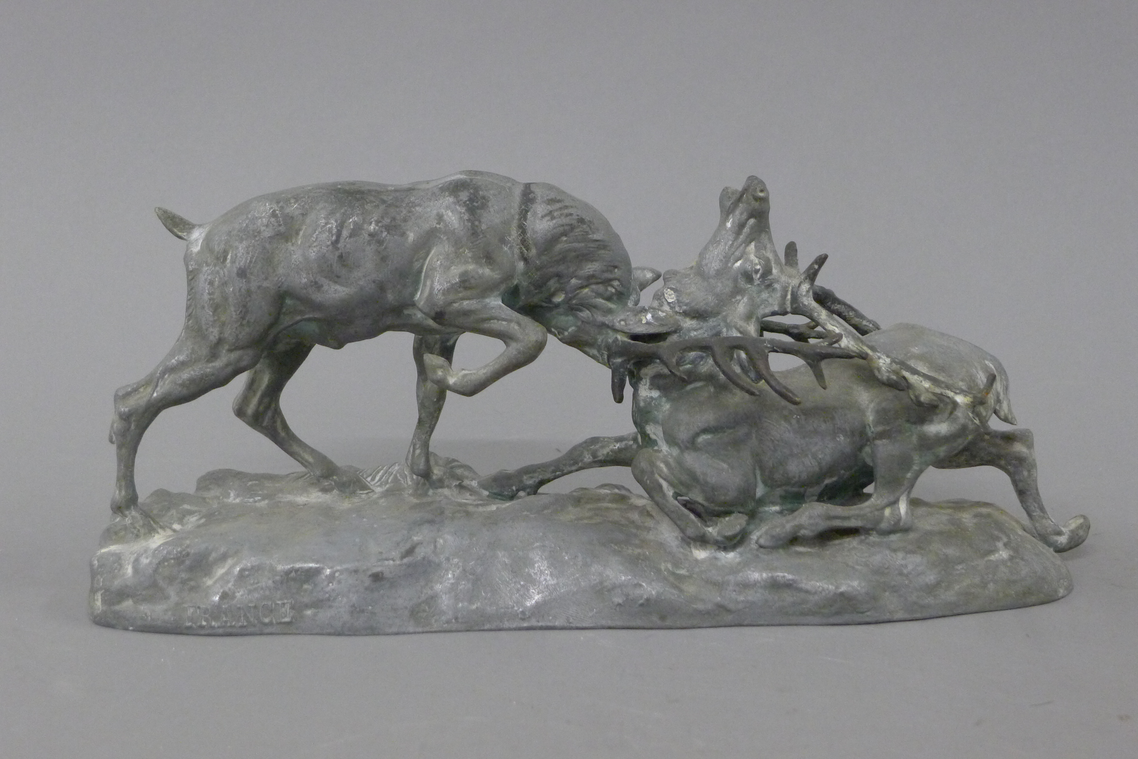 A spelter model of fighting stags. 32.5 cm long.