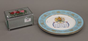 A pair of Aynsley bone china Royal Commemorative plates and a glass box.