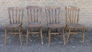 Four Victorian elm seated splat back chairs.