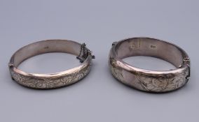 Two silver half engraved bangle formed bracelets. Internal diameter 5.75 cm and 6 cm respectively.