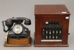 A bakelite telephone with bell box and exchange. The exchange 29.5 cm wide.