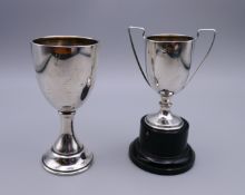 A small silver trophy cup on plinth base and a small silver goblet.