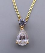 A 14 K gold cubic zirconia pear shaped pendant on a 14 K gold chain. Pendant 1.