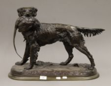 A large patinated bronze model of a dog holding a pheasant, the base inscribed J Moigniez.