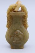 A jade urn form pendant. 6 cm high.