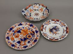 Three porcelain plates decorated in the Imari palette.