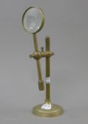 A brass magnifier on stand.