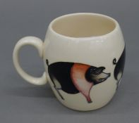 A Moorcroft Saddleback Pig mug. 9 cm high.