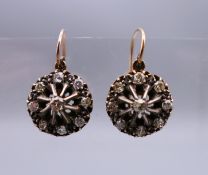 A pair of Edwardian unmarked gold and silver old cut diamond earrings.