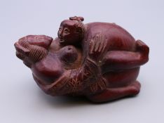 An erotic figural group. 7 cm long.