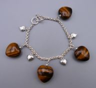 A silver and tiger's eye bracelet. 18 cm long.