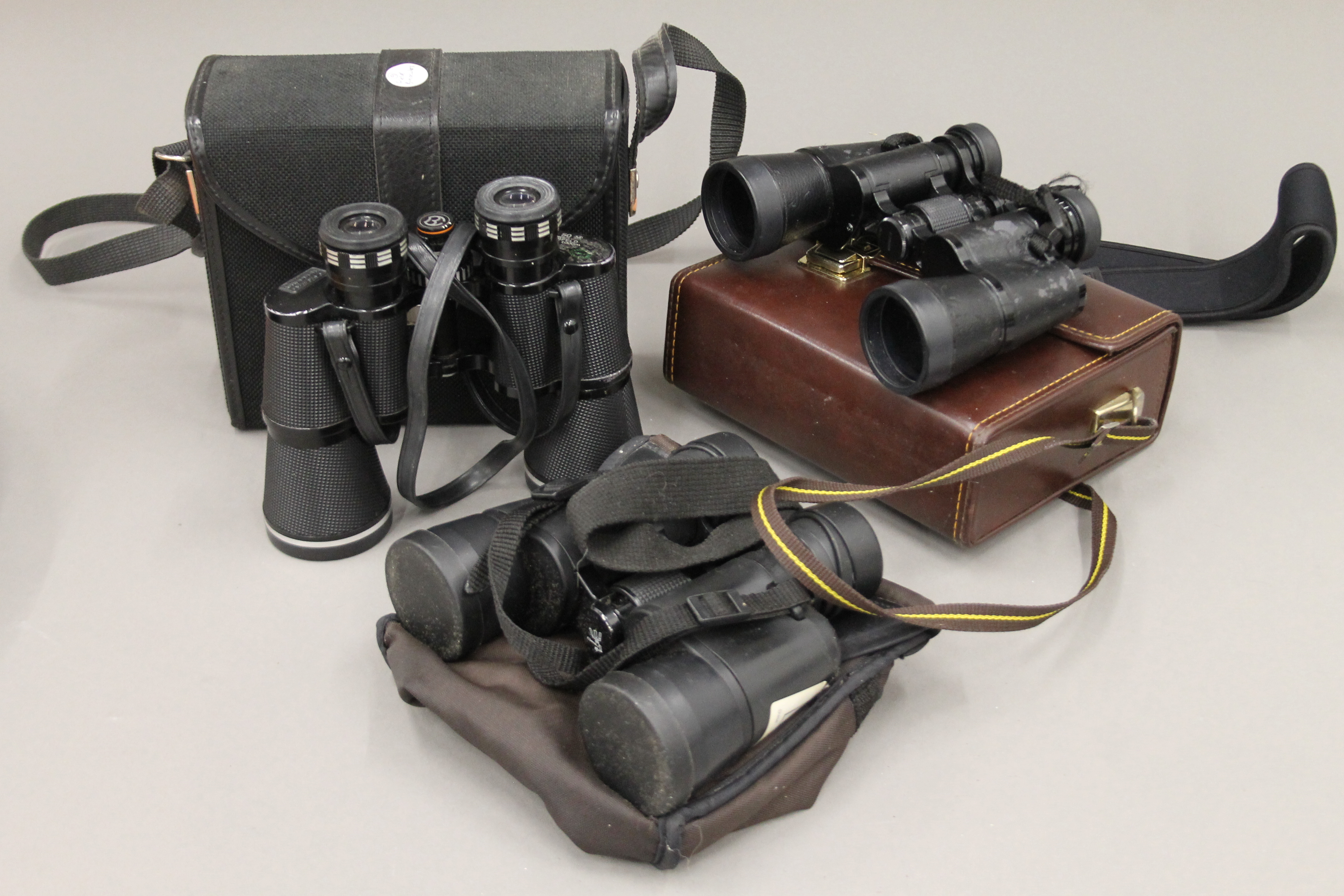 Three pairs of field binoculars.