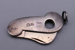 A silver cigar/cigarillos cutter. 4 cm high excluding suspension loop.