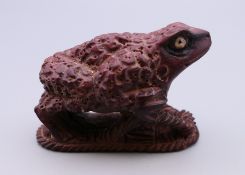 A netsuke formed as a frog. 5.5 cm long.