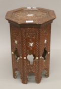 A small 19th century Middle Eastern inlaid octagonal wooden table. 41 cm high.