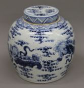 A large Chinese blue and white porcelain bulbous shaped ginger jar decorated with dogs of fo.