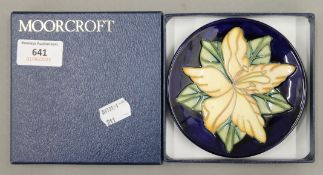 A boxed Moorcroft Triang pin dish. 11.5 cm diameter.