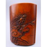 A Japanese carved wooden inro depicting mountains and a dragon amongst clouds. 7.5 cm x 5.5 cm.