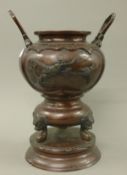 A Japanese bronze twin handled vase. 30 cm high.