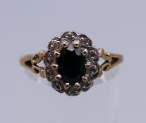 A 9 ct gold ring with central sapphire surrounded by diamonds. Ring size S/T. 2.
