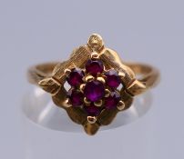 A 9 ct gold ring with flowerhead setting. Ring size N/O. 2.6 grammes total weight.
