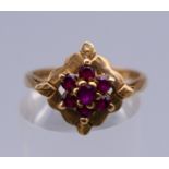 A 9 ct gold ring with flowerhead setting. Ring size N/O. 2.6 grammes total weight.