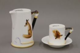 A Royal Doulton Reynard the Fox coffee can and saucer, and a cream jug. The latter 11 cm high.