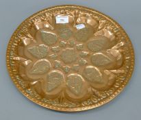 An Eastern embossed copper dish. 34 cm diameter.