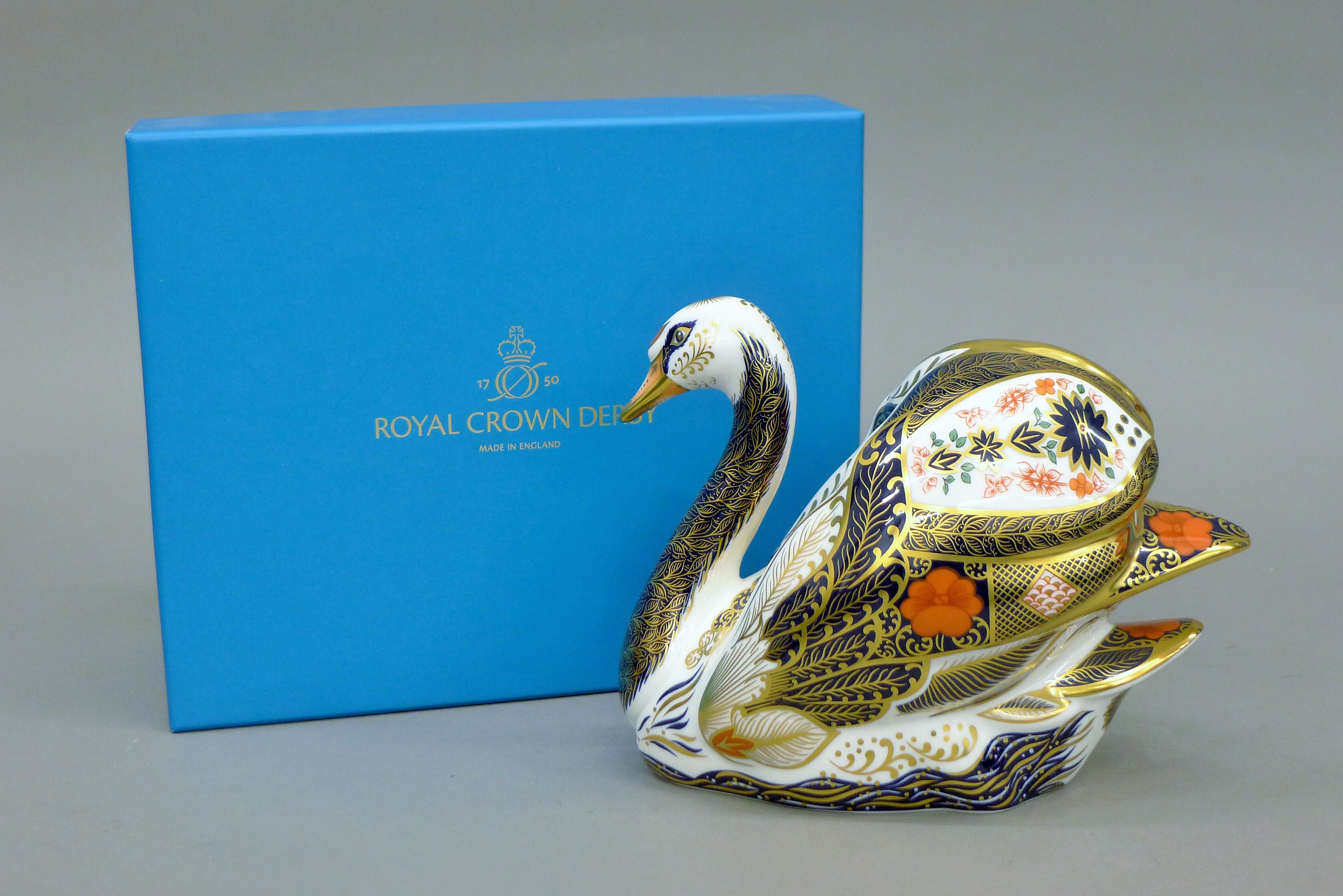 A boxed Royal Crown Derby Old Imari Solid Gold Band Swan paperweight.