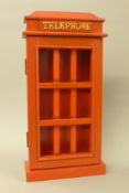 A key rack formed as a red telephone box. 45.5 cm high.