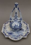 An Art Nouveau style Delft blue and white porcelain vase and a Delft porcelain wall plate.