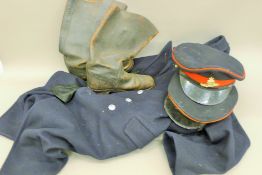 A military ARP coat, two hats and a pair of military flying boots.