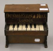 A Dunmo Ellis & Hill London child's piano. 21 cm wide.