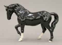 A boxed Beswick Black Jogging Mare.