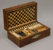 A Victorian oak fitted games box. 30.5 cm wide.