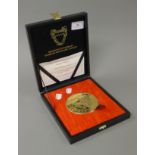 A boxed Kingdom of Bahrain Monetary Agency Commemorative gold plated silver medallion in a