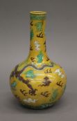 A Chinese porcelain yellow ground vase decorated with dragons. 23 cm high.