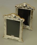 A pair of silver photograph frames. 21.5 cm high.