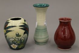 Three small Moorcroft vases. The largest 13 cm high.