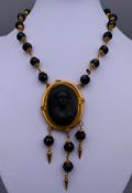 A Victorian black bead and black cameo pendant necklace/choker.