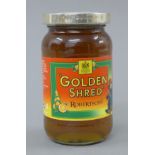 A silver lidded jar of Golden Shred Marmalade.