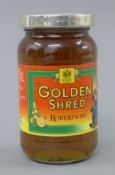 A silver lidded jar of Golden Shred Marmalade.