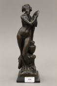 An Art Nouveau bronze model of a lady looking in a mirror mounted on a display plinth. 30 cm high.